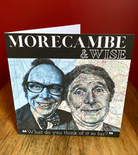 Load image into Gallery viewer, Morecambe and Wise Greeting Card.Printed drawing over maps. Blank inside.
